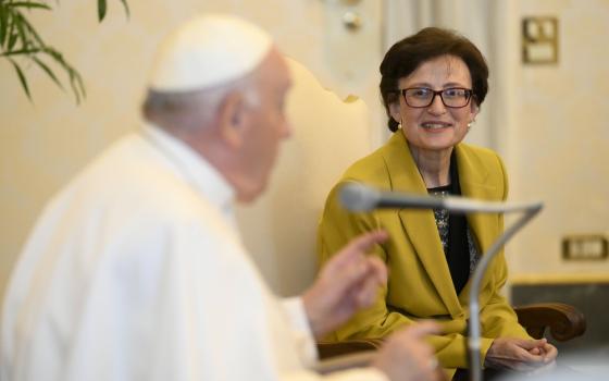 Pope Francis seated in foreground; in-focus is Sr. Nuria Calduch-Benages.