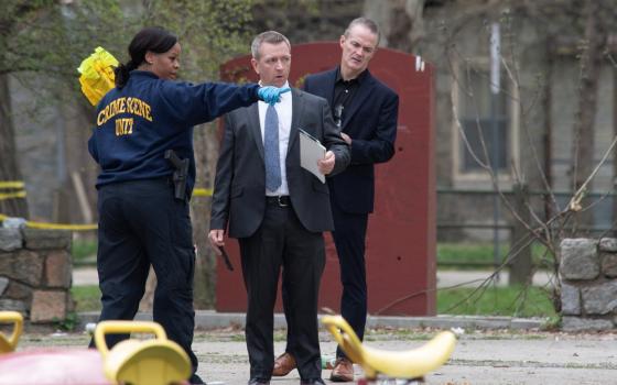 Law enforcement officials examine scene of shooting