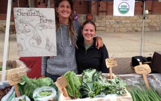 Ashley Neises, left, and Andie Donnan sell some of the produce they raise on Sandhill Farm.