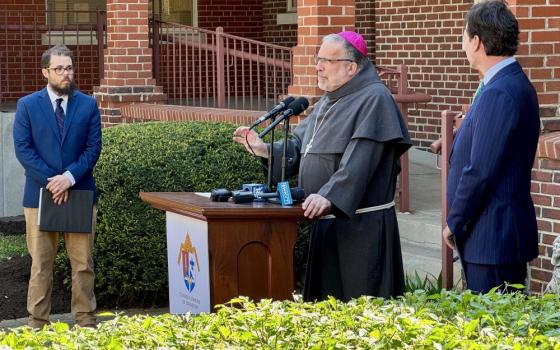 Bishop John Stowe of Lexington, Kentucky, center, speaks at press conference. With him are Bishop John Stowe of Lexington, Kentucky, announces a net-zero initiative.  With him are Adam Edelen (right), founder and CEO of Edelen Renewables, and Joshua Van Cleef (left).