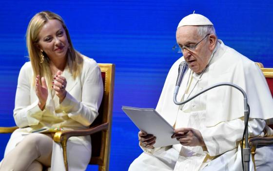 Italian Prime Minister Giorgia Meloni applauds Pope Francis during a meeting about families and Italy's declining birthrate May 12, 2023, in Rome.