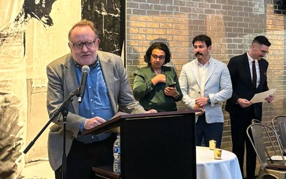 Chris Herlinger, international correspondent for Global Sisters Report, accepts an award from the Religion News Association on behalf of GSR staff for the series "Hope Amid Turmoil" at an April 20 ceremony at the Warhol Museum in Pittsburgh. (GSR photo/Olivia Bardo)