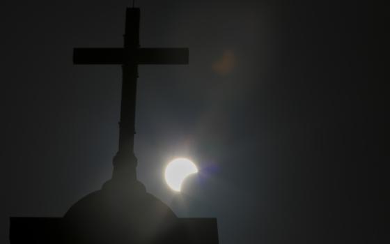 essay about my experience with god in a sacred place Cross silhouetted against eclipsing sun