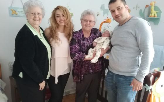 Franciscan Oblates of St.-Joseph Srs. Gabrielle Servant and Pierette Bertrand visit a Syrian family and their newborn in 2017. They started working with refugees in 2012 when Syrian refugees came to Canada after the war in Syria.