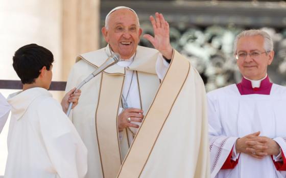 Pope Francis smiles and waves to visitors after reciting the Angelus prayer, wrapping up the first World Children's Day in St. Peter's Square at the Vatican May 26. (CNS/Lola Gomez)