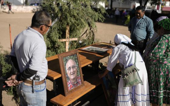 People gather around outdoor altar