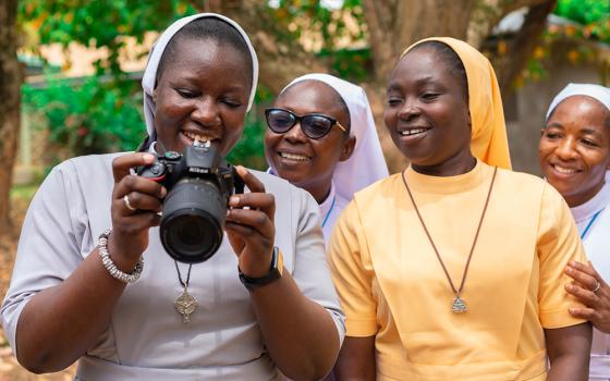 Handmaids of the Holy Child Jesus Sr. Emmanuel Dakurah (holding camera), Sisters of Mary Immaculate Sr. Juliana Atuuna, Daughters of the Most Holy Trinity Sr. Patricia Akoto, and  Sisters of Mary Immaculate Sr. Gloria Duongnaa, practice using a camera at a training session May 9 at Santasi in Ghana's Kumasi Archdiocese. (Newswatchgh.com/Damian Avevor)