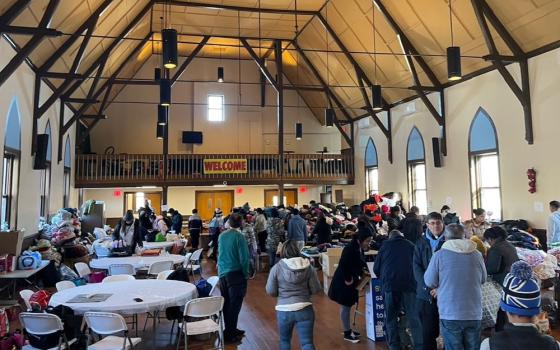 Migrants from a nearby encampment can take free clothing through the work of parishioners at St. Thomas Aquinas Church in Brooklyn. The clothing site takes place in the parish meeting hall. (Courtesy of St. Thomas Aquinas Church)
