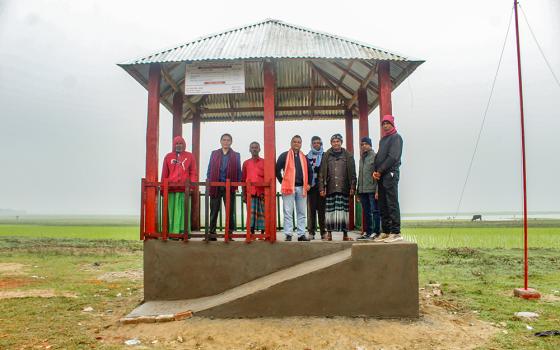 Boniface Khonglah (fourth from left), the regional director of Caritas Sylhet Region, alongside other local leaders, visits the lightning protection shelter at Panchauniya Haor in the Baniachang subdistrict of Habiganj district, Bangladesh, Jan. 17. (Courtesy of Caritas Bangladesh)