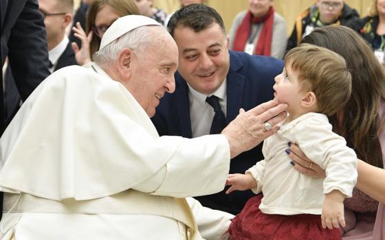 Pope Francis greets child from wheelchair