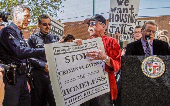 Catholic Worker Jeff Dietrich, center, protests in Los Angeles in 2010. (AP/Reed Saxon)