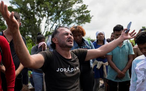 A migrant prays Aug. 22 in Sayula de Aleman, Mexico, along with others during a pause on their journey toward the U.S. border. (OSV News/Reuters/Angel Hernandez)