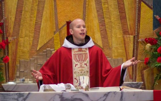 Franciscan Fr. Daniel P. Horan celebrates Mass in May 2012. Horan has announced his departure from the Franciscan order. (The Catholic Sun/Charles Wainwright)