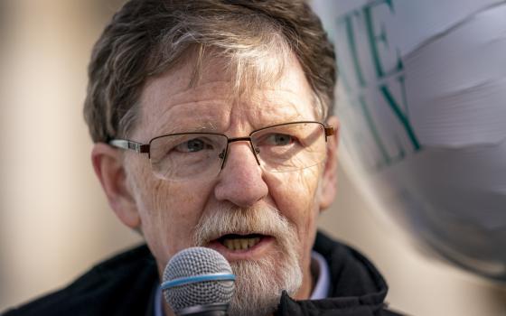 Close-up of Phillips speaking into microphone. 