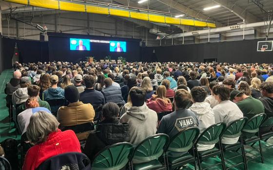 Students, staff and visitors at Siena College in Loudonville, New York, watch a video message from U.N. Secretary-General António Guterres in the Marcelle Athletic Center Oct. 10 at the opening of the Franciscan school's symposium on integral ecology. (Courtesy of Siena College)