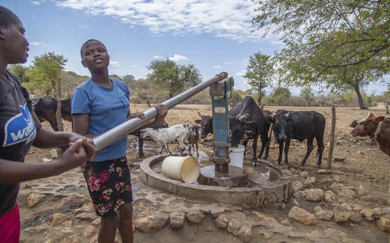 Villagers pump water at a borehole July 2 in Mudzi, Zimbabwe. The United Nations' food agency said Oct. 15 that months of drought in southern Africa, triggered by the El Nino weather phenomenon, has had a devastating impact on more than 27 million people and caused the region's worst hunger crisis in decades. (AP photo/Aaron Ufumeli/File)
