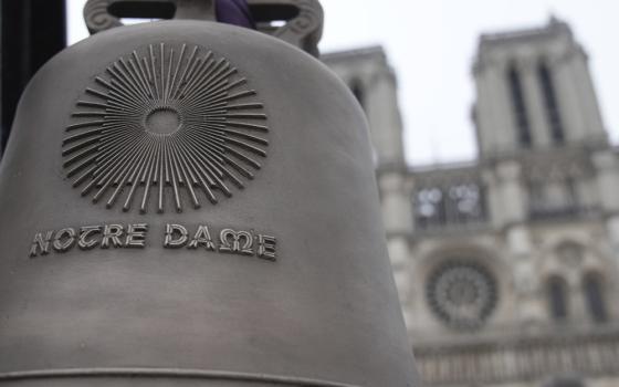 Bell in foreground, front of Cathedral backgrounded.