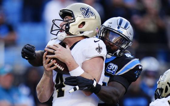 Action shot of one player tackling another.