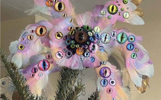 This Dec. 12, 2021, photo shows the biblically accurate angel Christmas tree topper created by the Rev. Kira Austin-Young and her puppet-maker husband, Michael Schupbach, atop the tree in their former home in Nashville, Tenn. (Kira Austin-Young via AP)