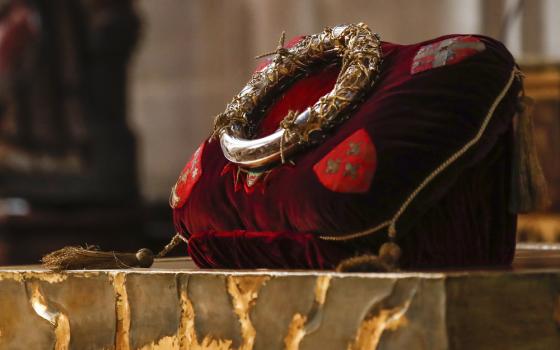 Relics sits gleaming on red cushion. 