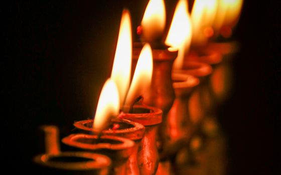 Hanukkah lights (Unsplash/Alla Kemelmakher)