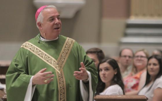 The archbishop vested for ordinary time speaks.