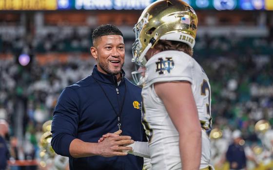 Notre Dame head coach Marcus Freeman greets a player before the Orange Bowl NCAA College Football Playoff semifinal game against Penn State, Thursday, Jan. 9, 2025, in Miami Gardens, Fla. (AP/Rebecca Blackwell)