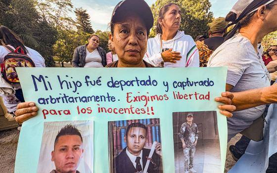 During a Jan. 12, 2025, protest in San Salvador, El Salvador, Albertina Jovel Escobar holds a sign showing her son who was deported and sent to prison as soon as he landed in his home country. A group of Catholic mothers like Jovel warned that those deported to El Salvador could be sent straight to prison without due process, as the U.S. is in talks with the Salvadoran government about taking in deported migrants from different countries. (NCR photo/Rhina Guidos)