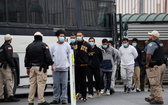 Migrants are escorted Jan. 27, 2025, across the Hidalgo International Bridge in McAllen, Texas, at the U.S.-Mexico border as they are deported under Title 8, a law that allows for immediate deportation after individuals cross into the U.S. without authorization. (OSV News/Reuters/Daniel Becerril)