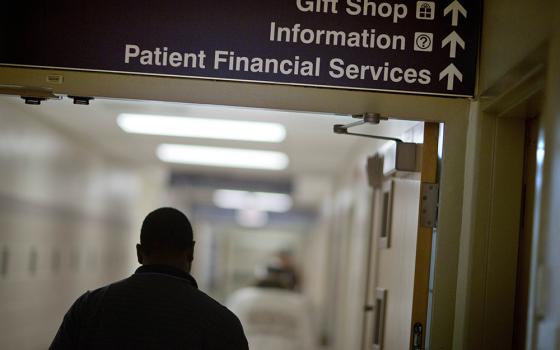 A sign points visitors toward the financial services department at a hospital in this file photo. The Catholic Health Association has issued a plea to congressional leadership asking them to reject funding cuts and structural changes to Medicaid. (AP photo/David Goldman, File)