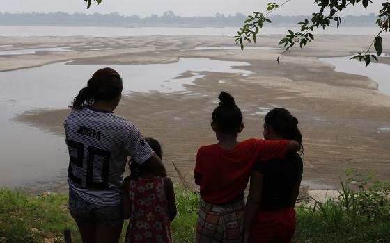 Residents look out at the Madeira River, a tributary of the Amazon River amid a drought in Humaita, Amazonas state, Brazil, Sept. 7, 2024. "Fraternity and Integral Ecology" is the theme of this year's Fraternity Campaign, a Lenten effort by the National Conference of Bishops of Brazil to collect funds for its social works and raise awareness of a pressing issue. (AP photo/Edmar Barros, File)
