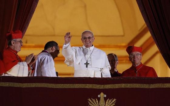 Pope Francis waves from the central balcony of St. Peter's Basilica following his election March 13, 2013. Pope Francis died April 21. (CNS/Paul Haring)