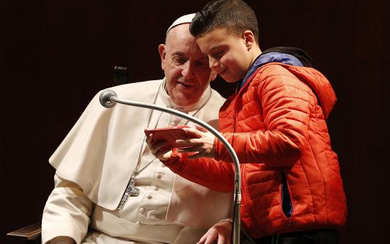 A boy takes a selfie with Pope Francis as the pope meets children before celebrating Mass at St. Mary Josefa Parish in Rome on Feb. 19, 2017. (CNS/Paul Haring)