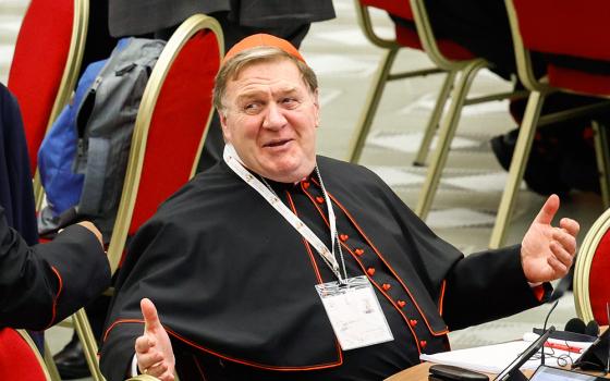 Cardinal Joseph Tobin of Newark, N.J., shares a moment with another cardinal during a break in the opening session of the Synod of Bishops in the Vatican's Paul VI Audience Hall Oct. 2, 2023. (CNS/Lola Gomez)