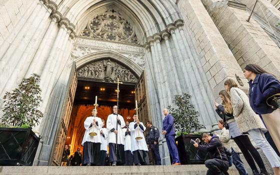 Seminarians lead a eucharistic procession from St. Patrick's Cathedral in New York City Oct. 15, 2024. A few thousand worshippers packed the cathedral for Holy Hour and Mass before participating in the procession through Midtown Manhattan. The event was a collaboration of the Napa Institute and the Hallow prayer app. (OSV News/Gregory A. Shemitz)