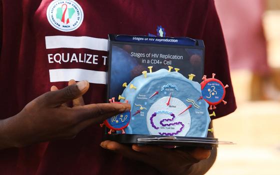 Peer educator Abraham Nnam uses a model of the HIV virus to illustrate a lesson on AIDS to youths at a primary health center in Kobi suburb, Abuja, Nigeria, Nov. 30, 2022. The future of PEPFAR, the U.S. government's global effort to combat HIV/AIDS, is unclear amid a pause on foreign assistance triggered by a Jan. 20, 2025, executive order from President Donald Trump. (OSV News/Reuters/Afolabi Sotunde)