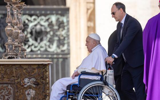Pope Francis is brought on stage in St. Peter's Square by his nurse, Massimiliano Strappetti, at the end of the closing Mass for the Jubilee of the Sick and Health Care Workers at the Vatican April 6, 2025. (CNS/Pablo Esparza)