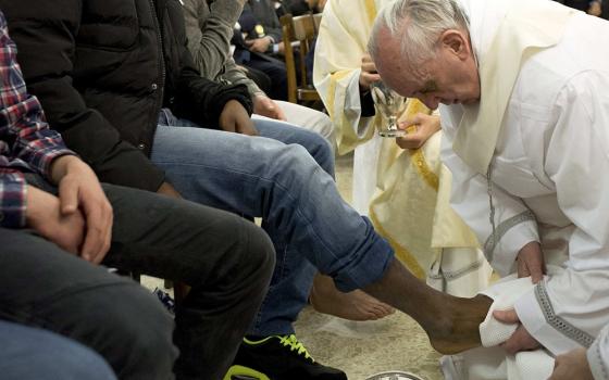 Pope Francis washes the foot of a prison inmate during the Holy Thursday Mass of the Lord's Supper at Rome's Casal del Marmo prison for minors March 28, 2013. (CNS/L'Osservatore Romano via Reuters)
