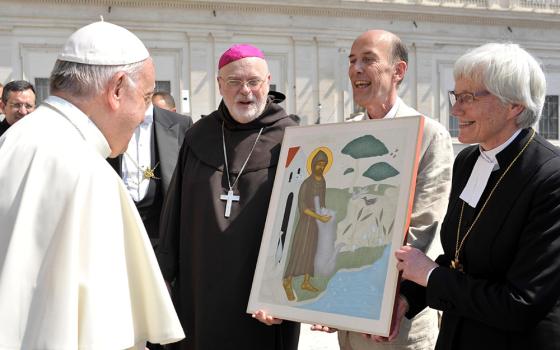 Cardinal Anders Arborelius of Stockholm and Lutheran Archbishop Antje Jackelen of Uppsala, primate of the Church of Sweden, present Pope Francis with an icon of St. Francis of Assisi following the pope's general audience June 14, 2017, at the Vatican. The artist, Lars Gerdmar, held the icon during the presentation of the gift, which was an expression of gratitude for Pope Francis' visit to Sweden in October 2016. (CNS/L'Osservatore Romano)