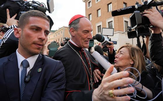 Cardinal François-Xavier Bustillo of Ajaccio, France, is surrounded by members of the media as he approaches the Petriano entrance next to St. Peter’s Square to attend a general congregation meeting in the New Synod Hall at the Vatican April 25, 2025. (CNS/Lola Gomez)