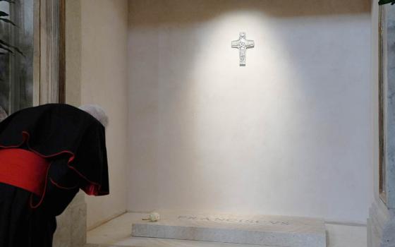 A member of the College of Cardinals prays at the tomb of Pope Francis and attends vespers at the Basilica of St. Mary Major in Rome April 27, 2025. Cardinals and the faithful visited the Marian basilica to offer their prayers and respects. (CNS/Lola Gomez)