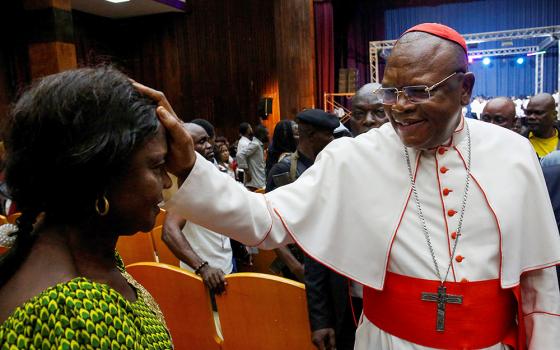 Cardinal Fridolin Ambongo Besungu blesses a woman during a gospel music festival in Kinshasa, Democratic Republic of Congo, Jan. 29, 2023. (OSV News photo/Luc Gnago, Reuters)