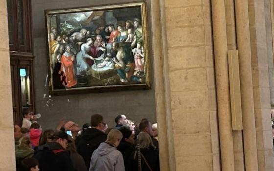 Mass attendees fill Notre-Dame de Paris on April 23, two days after Pope Francis died at age 88. The painting is "The Nativity" by Jérôme Francken. (NCR photo/Jason Berry)