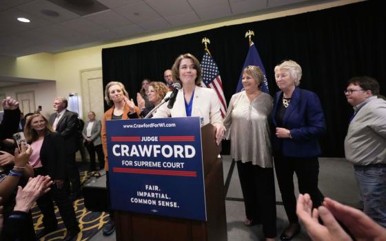 Wisconsin Supreme Court candidate Susan Crawford, surrounded by smiling staffers and clapping voters, speaks during her election night party after winning the election Tuesday, April 1, 2025, in Madison, Wis. (AP Photo/Kayla Wolf)