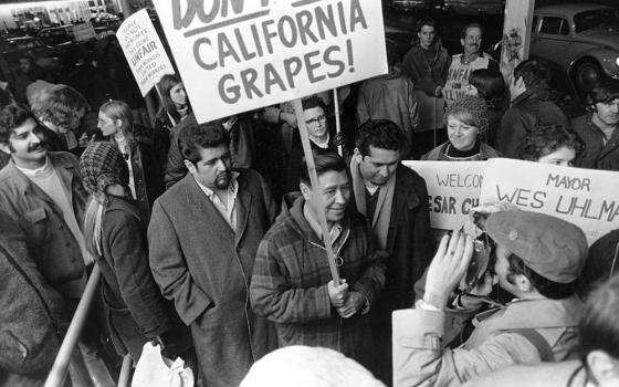 United Farm Workers President Cesar Chavez, carrying a sign calling for a boycott of California table grapes, leads about 400 people picketing a Safeway supermarket in Seattle, Washington, on Dec. 19, 1969. (AP photo/Barry Sweet)