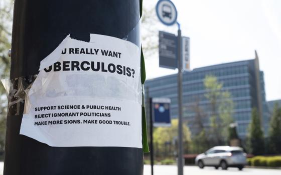 A sign about tuberculosis taped to a light pole across the street from the Centers for Disease Control and Prevention headquarters April 1 in Atlanta. (AP photo/Ben Gray)