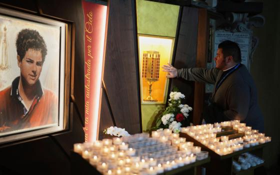 Rev. Cristopher Pujol prays at the heart relic of Carlo Acutis, the 15-year-old Italian boy who died in 2006 of leukemia and beatified in 2020, at the San Rufino Cathedral in Assisi, Italy, Wednesday, April 2, 2025.