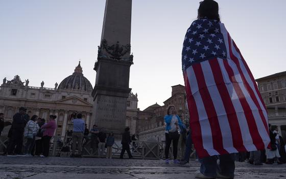 Andrea Gallardo, 20, from Texas, wears a flag of the United States after Pope Leo XIV appeared on the balcony of St Peter's Basilica following his election, at the Vatican, on May 8, 2025. (AP photo/Paolo Santalucia)