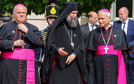 Metropolitan Archbishop Fulop Kocsis of Hajdudorog, Hungary, center, speaks with then-Archbishop Robert Francis Prevost, prefect of the Dicastery for Bishops, as they await the arrival of Pope Francis at the Buda Castle in Budapest on April 28, 2023, during his apostolic visit to Hungary. Archbishop Michael Wallace Banach, apostolic nuncio to Hungary, stands at the left. Prevost was named a cardinal in 2023 and was elected pope May 8, 2025. (Courtesy of Magyar Kurir/Attila Lambert)