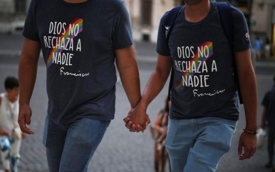 Members of the LGBTQ+ community, wearing T-shirts reading "God does not reject anyone" in Spanish, arrive to attend a vigil prayer in the Church of theGesù in central Rome Sept. 5. (AP /Andrew Medichini)